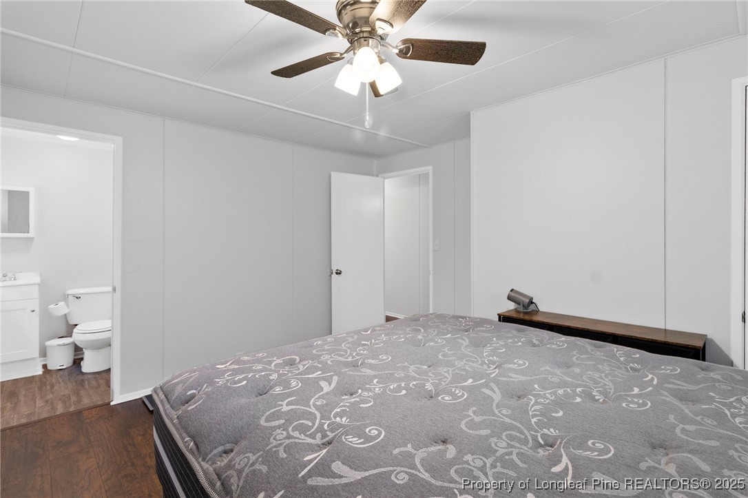 4112 Legion Road Hope Mills, NC 28348 - Photo 16 of 22 a bedroom with a bed and a chandelier