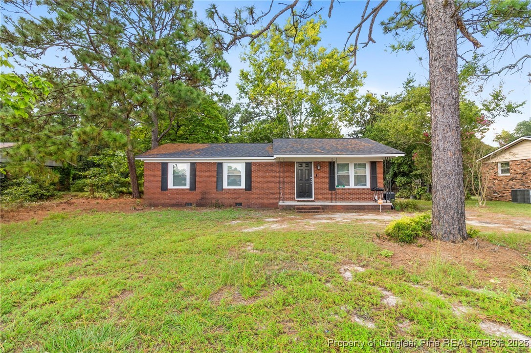4112 Legion Road Hope Mills, NC 28348 - Photo 2 of 22 a front view of a house with yard and green space