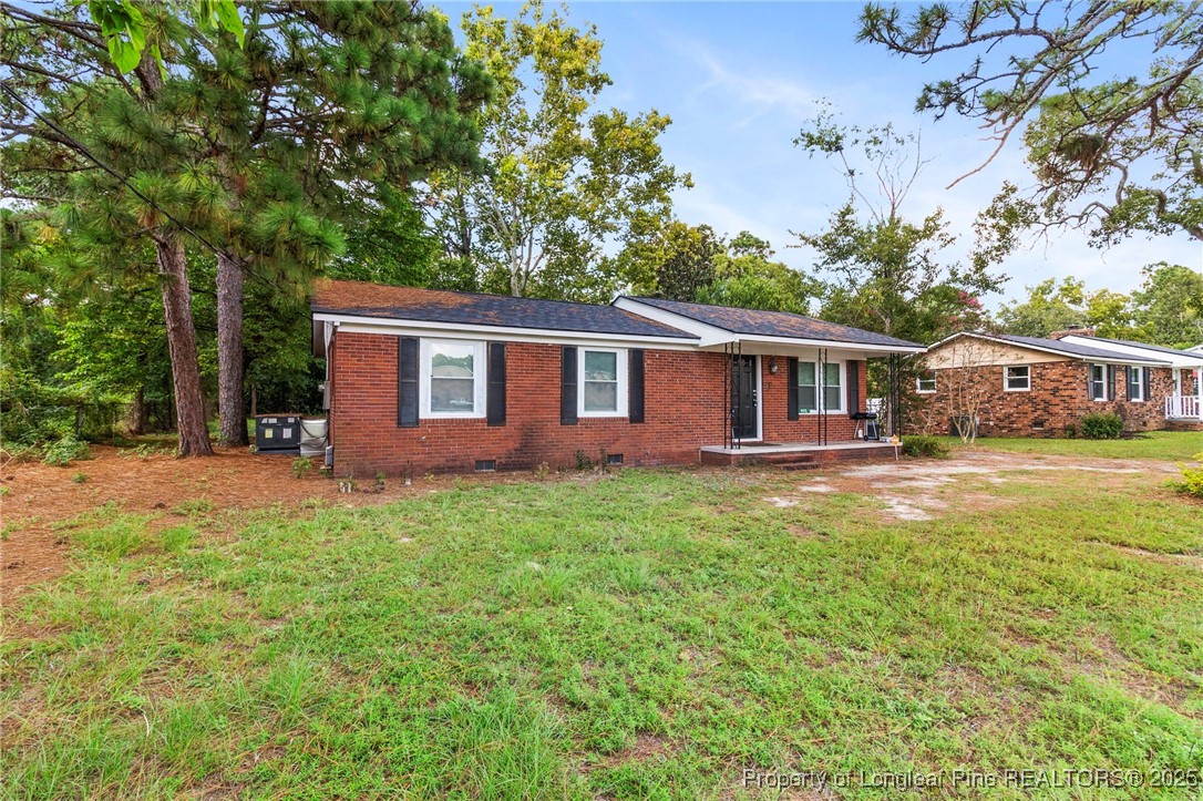 4112 Legion Road Hope Mills, NC 28348 - Photo 3 of 22 front view of a house with a yard