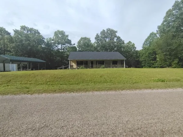 a view of a house with a yard and a garage