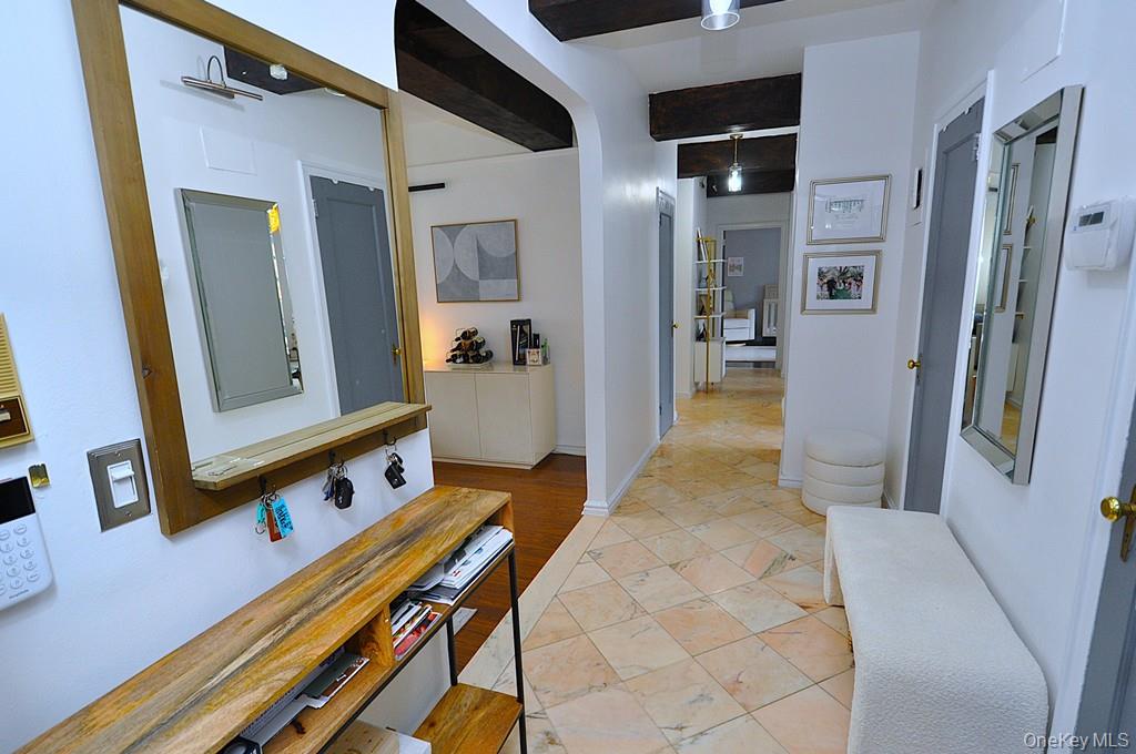 192 Garth Road, Unit TP Scarsdale, NY 10583 - Photo 31 of 43 A stunning marble-floored entry welcomes you into a light-filled home featuring charming courtyard views, soaring wood-beamed ceilings, gleaming hardwood floors, and an impressive eight oversized closets for exceptional storage.