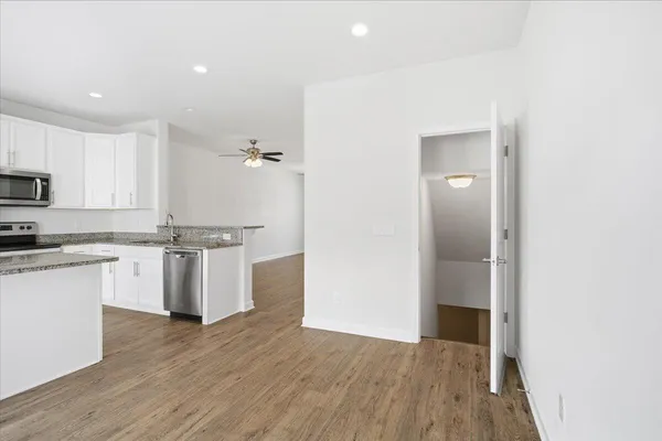 a kitchen with a refrigerator and white cabinets