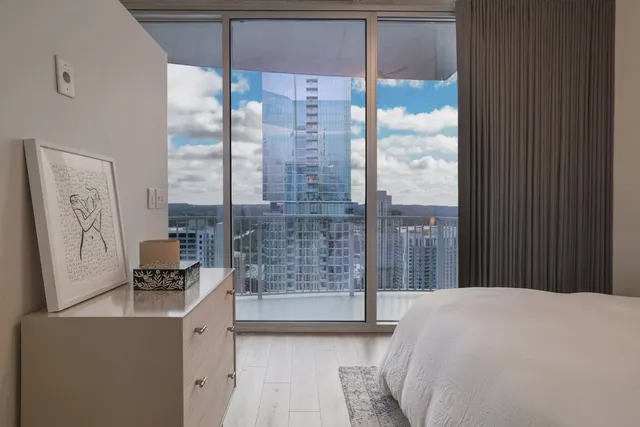 a bathroom with a granite countertop sink a toilet and a mirror
