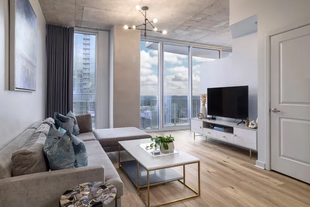 a living room with furniture and a flat screen tv
