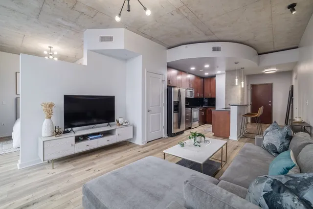 a living room with furniture and kitchen view