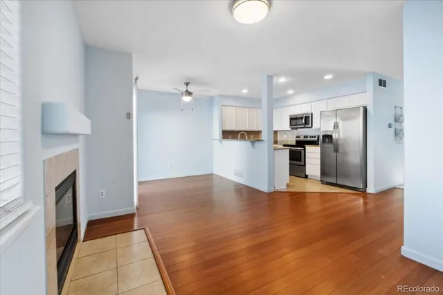 a view of a kitchen with a sink stove cabinets and empty room