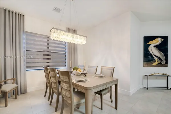 a view of a dining room with furniture and window