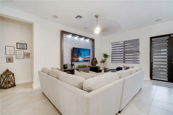 a living room with furniture and a large window
