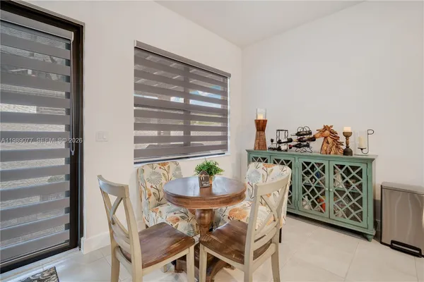 a bedroom with a bed chair and a window