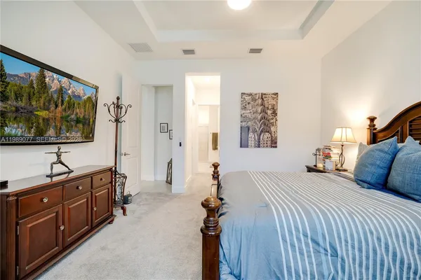 a bathroom with a sink a potted plant and a mirror