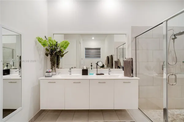 a bathroom with a tub sink and mirror