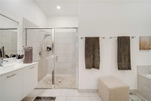 a bathroom with a sink a toilet a mirror and shower curtain