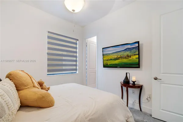 a bathroom with a sink a toilet and shower curtain