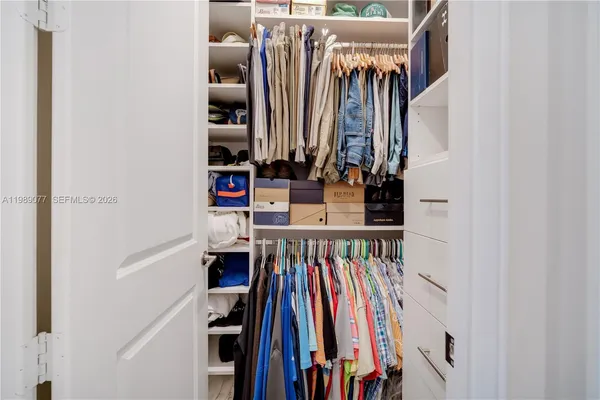 a view of a dining room with furniture and a chandelier