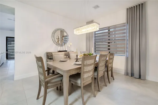 a front view of a house with a garden and yard