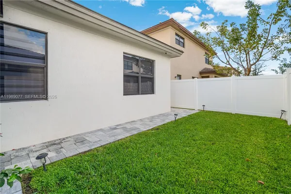 an aerial view of a house with a garden and lake view