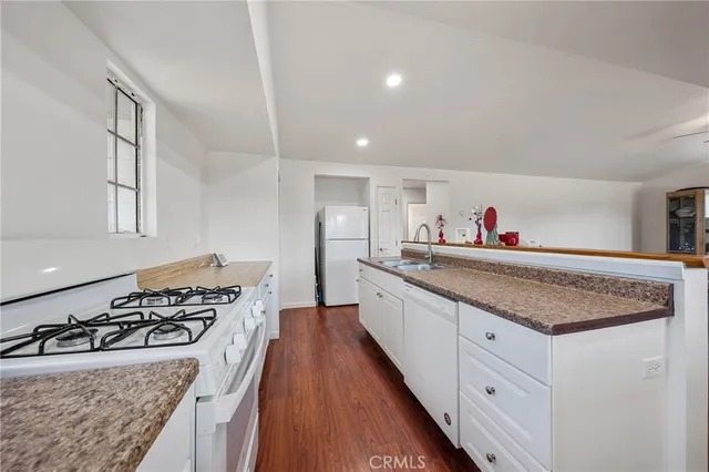 a kitchen with lots of counter top space and wooden floor