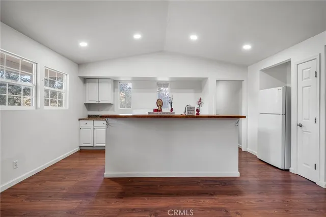 a kitchen with stainless steel appliances a refrigerator and a stove top oven
