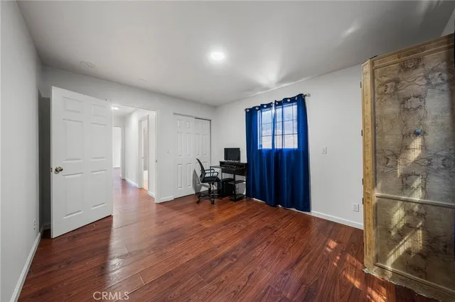 a view of a livingroom with wooden floor and a cabinet