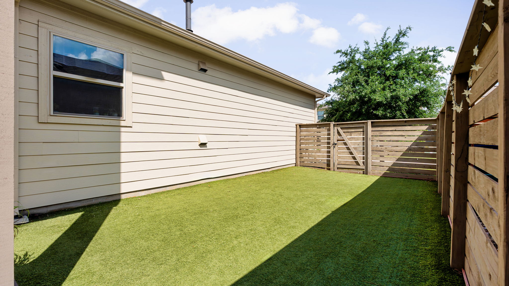1511 Lawrence Street Austin, TX 78741 - Photo 8 of 26 Outdoor space with artificial turf.