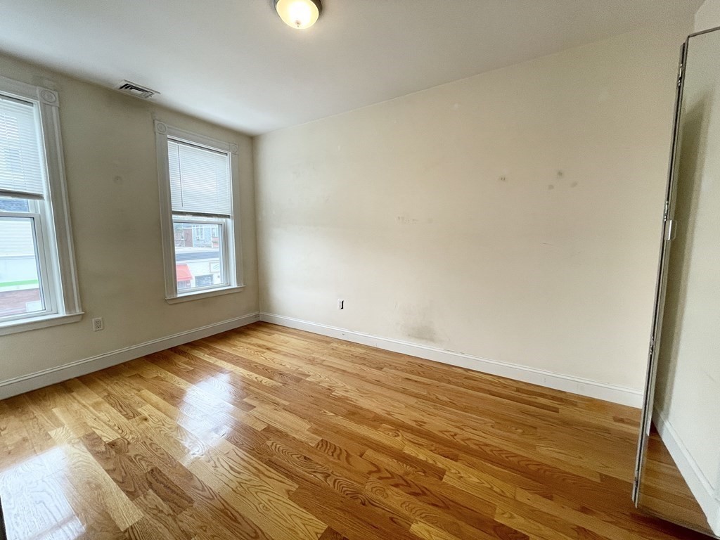 98 L Street, Unit STREET Boston, MA 02127 - Photo 14 of 19 a view of empty room with wooden floor and fan