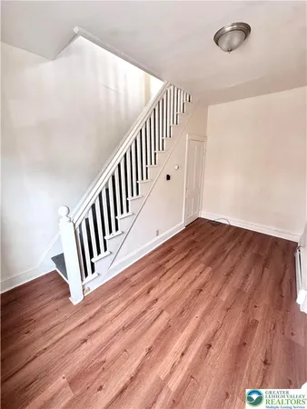 a view of staircase with wooden floor