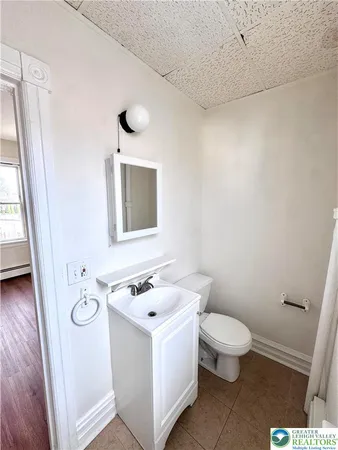 a white toilet sitting next to a bathroom sink
