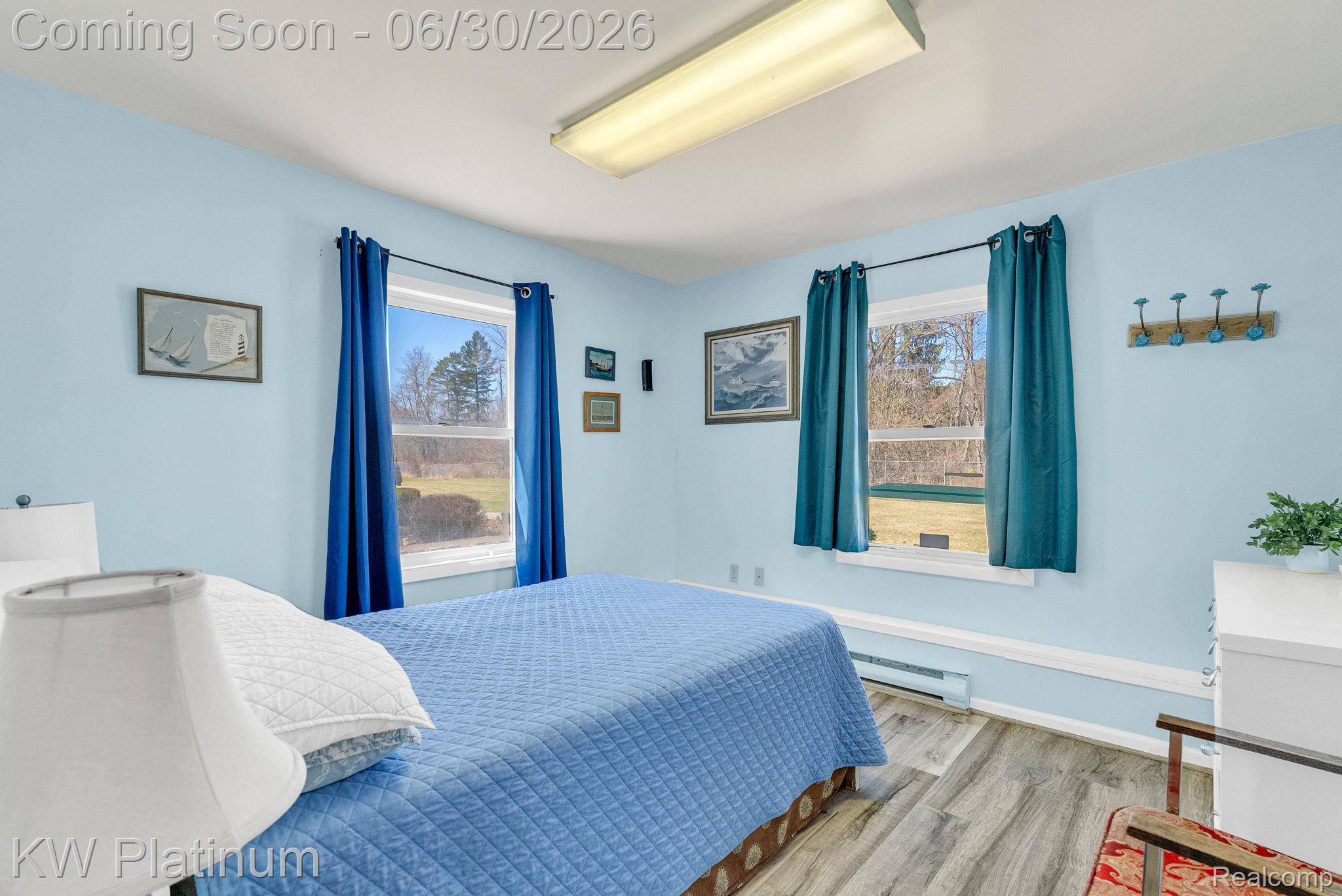 2235 South Lake Shore Road Harbor Beach, MI 48441 - Photo 65 of 99 Room featuring two windows with exterior views, wood-finish flooring, and light blue walls