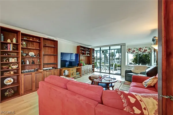 a living room with furniture and a floor to ceiling window or wooden floor