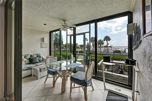 a living room with furniture and a floor to ceiling window