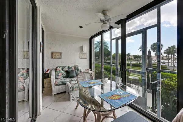 a living room with furniture and a floor to ceiling window