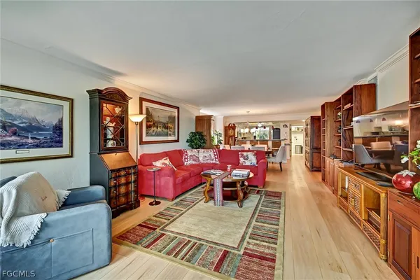 a living room with furniture a rug and a flat screen tv