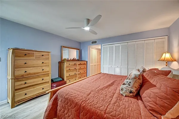 a bedroom with a bed and a closet