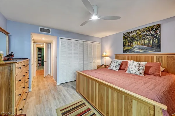 a bedroom with bed and wooden floor