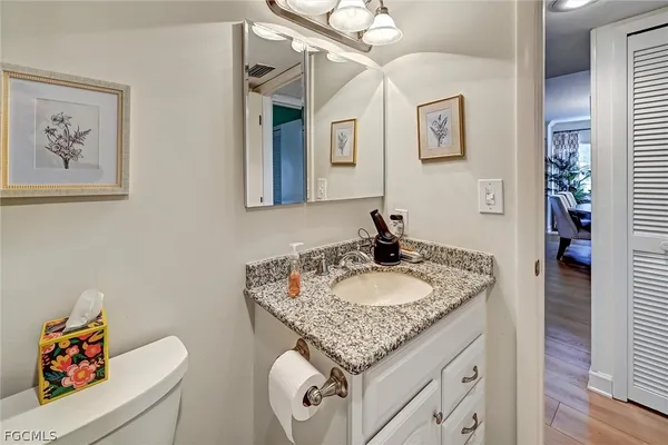 a bathroom with a granite countertop sink and a mirror