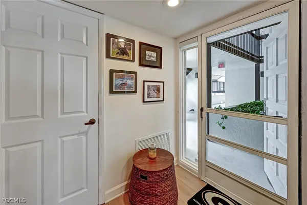 a hallway with closet and window