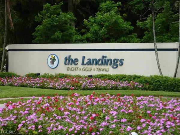 a street sign that is in front of flowers