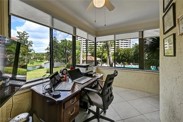 a living room with furniture and a floor to ceiling window