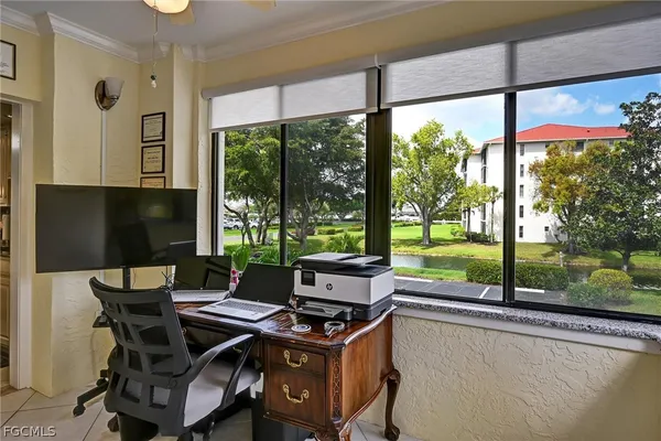 a view of a living room with furniture and garden view