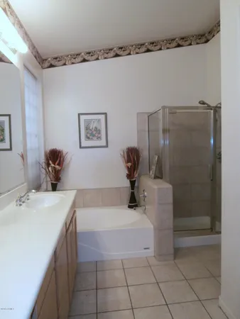 a bathroom with a tub sink and mirror