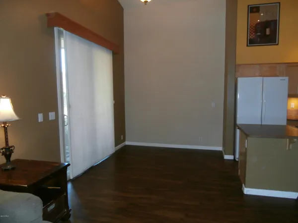 a view of a room with wooden floor and cabinet