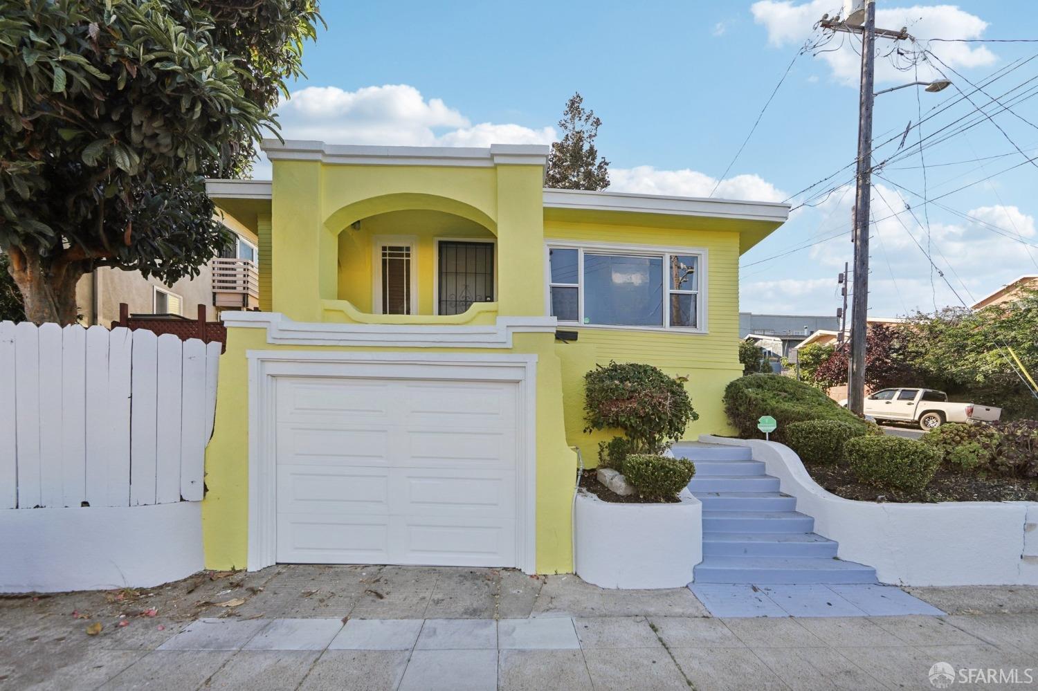 2047 36th Avenue Oakland, CA 94601 - Photo 1 of 19 a front view of a house with a garden