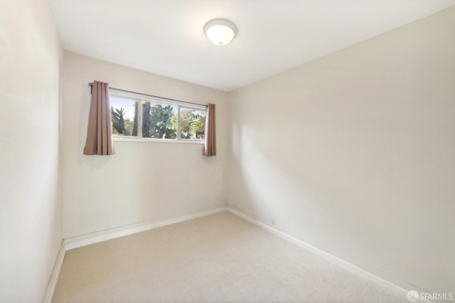 2047 36th Avenue Oakland, CA 94601 - Photo 17 of 19 an empty room with windows