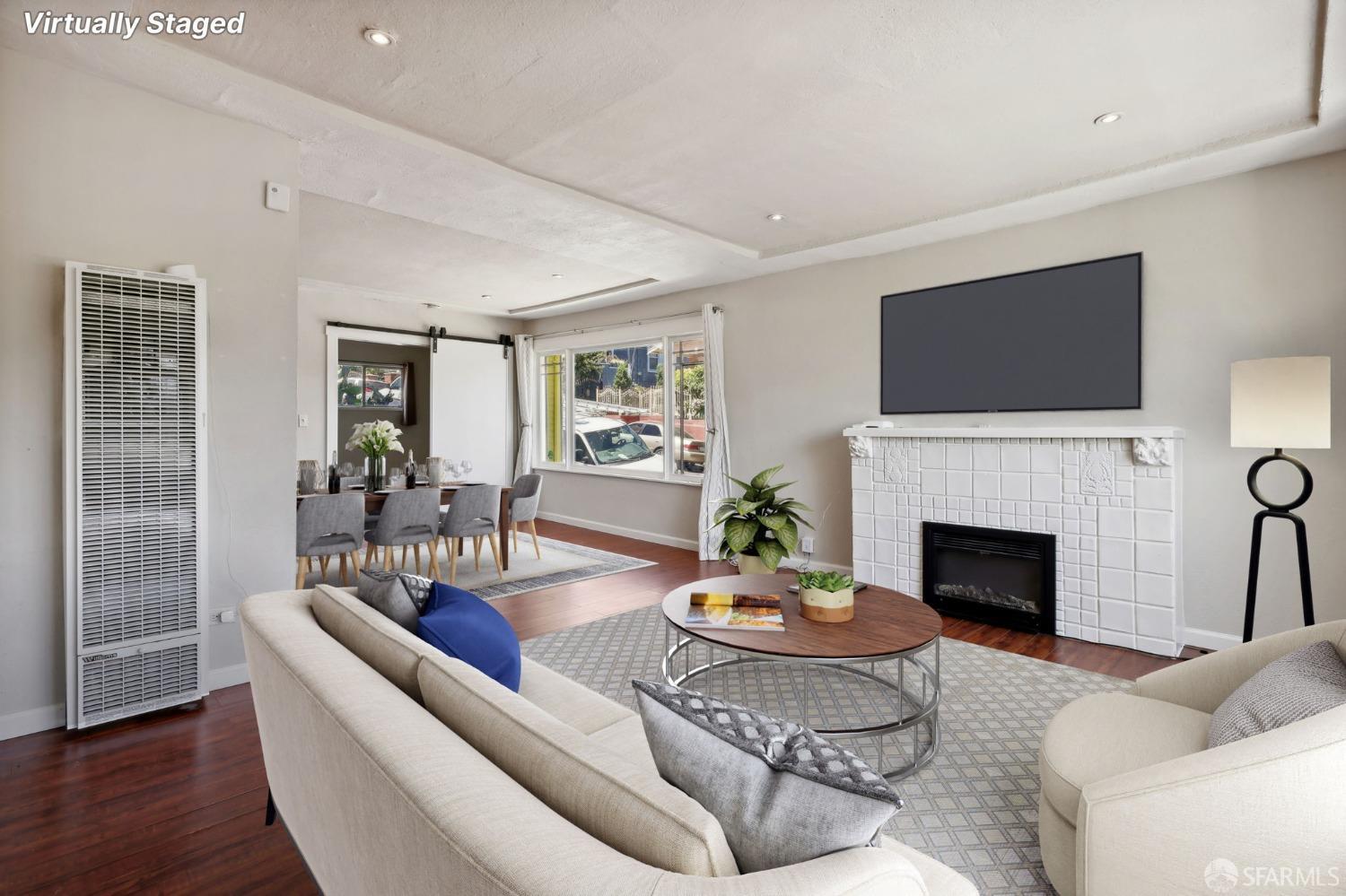 2047 36th Avenue Oakland, CA 94601 - Photo 4 of 19 a living room with furniture a fireplace and a flat screen tv
