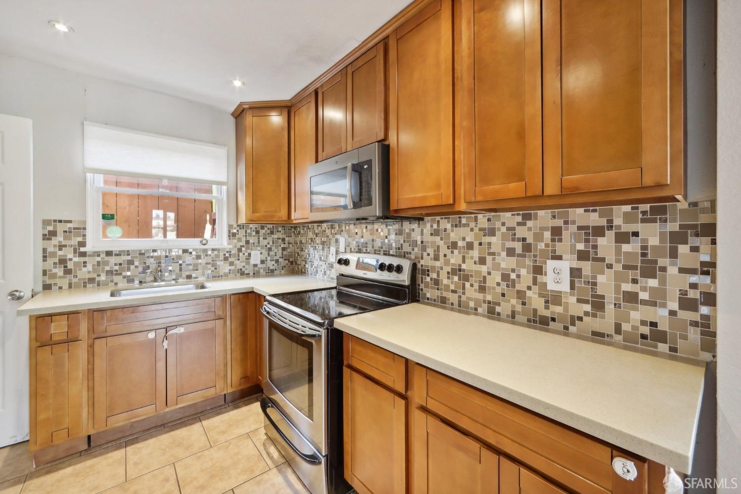 2047 36th Avenue Oakland, CA 94601 - Photo 5 of 19 a kitchen with a sink cabinets and window