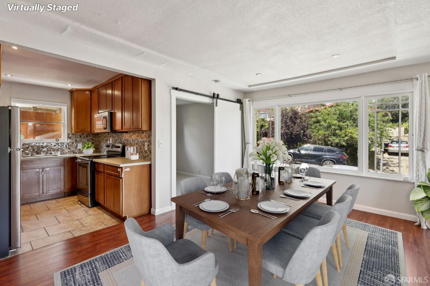 2047 36th Avenue Oakland, CA 94601 - Photo 6 of 19 a kitchen with a table chairs stove and refrigerator