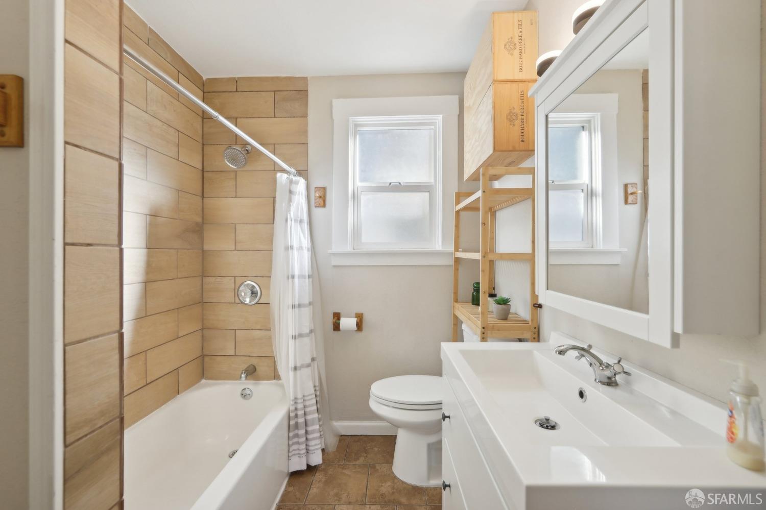 2047 36th Avenue Oakland, CA 94601 - Photo 7 of 19 a bathroom with a sink a toilet and shower