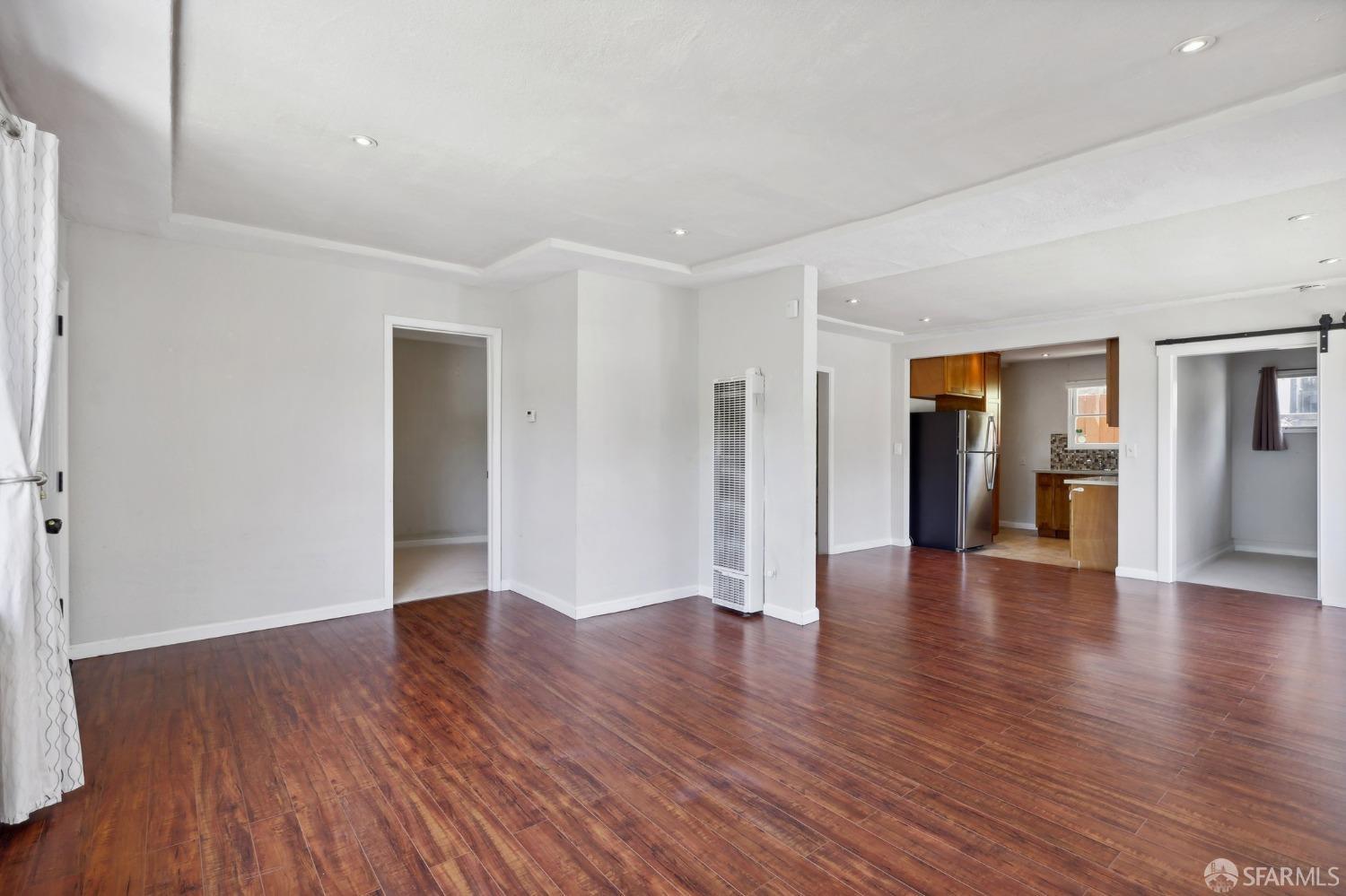 2047 36th Avenue Oakland, CA 94601 - Photo 8 of 19 a view of an empty room with wooden floor