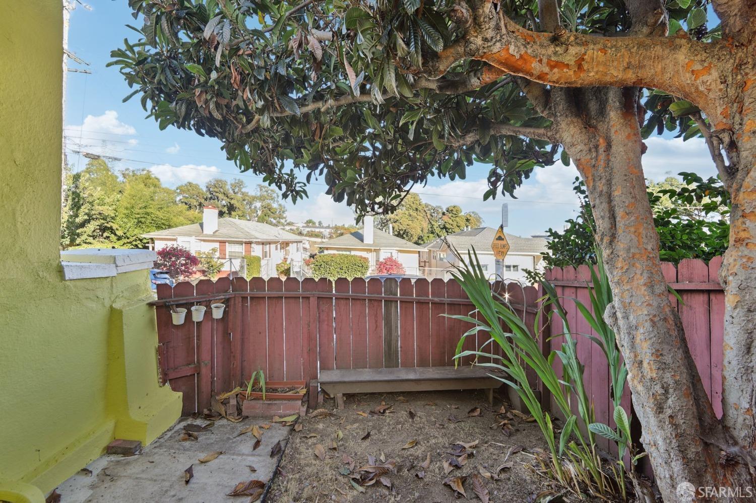2047 36th Avenue Oakland, CA 94601 - Photo 10 of 19 a view of a backyard with plants and wooden fence