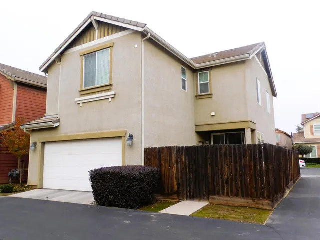a front view of a house with garage